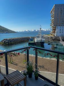 a boat is docked at a dock in the water at New Aptartment Ocean View Central in Tromsø