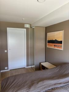 a bedroom with a bed and a sliding door at New Aptartment Ocean View Central in Tromsø