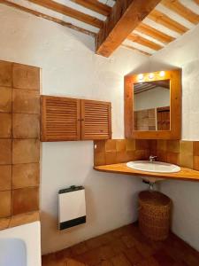 a bathroom with a sink and a mirror at Maison paisible au coeur du Luberon in Bonnieux