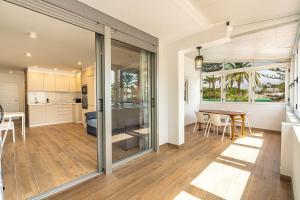 a kitchen and living room with sliding glass doors at Panarea Chaparal in Costa Del Silencio