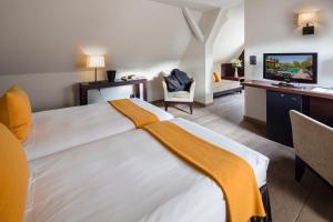 Postel nebo postele na pokoji v ubytování Hotel Restaurant De l'Illwald