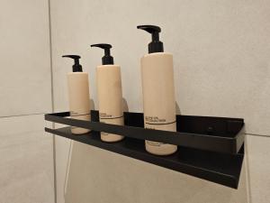 four rolls of toilet paper sitting on a shelf in a bathroom at The Dune house, Free parking in Zandvoort