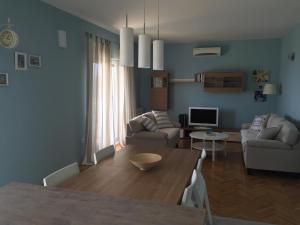 a living room with a table and a dining room at Apartments Rube in Primošten