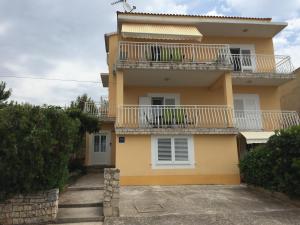 a house with balconies on the side of it at Apartments Rube in Primošten