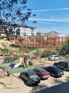 a playground with cars parked in a parking lot at Сдаётся однокомнатная квартира Люкс возле озера. in Balqash