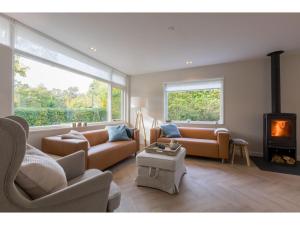 a living room with a couch and a fireplace at House in Oostkapelle near Beach & Sauna in Oostkapelle