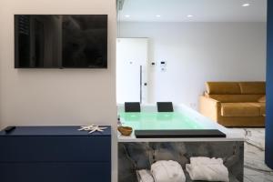 - un salon avec une baignoire et un canapé dans l'établissement Suite 18, à Polignano a Mare