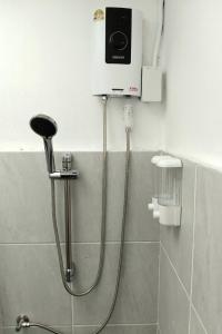 a shower in a bathroom with aperature at PaiPaiHostel in Pai