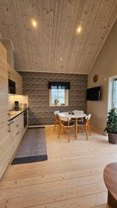 a kitchen with a table and chairs in a room at Hansingastugan Bed and Kitchen Guesthouse in Varberg +23 photos