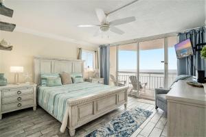 a bedroom with a bed and a balcony at 1201 Waters Edge Resort in Myrtle Beach +39 photos