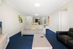 a living room with a couch and a table at Turtle Beach 250 in Gold Coast