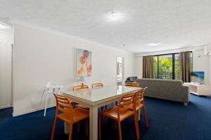a living room with a table and chairs and a couch at Turtle Beach 250 in Gold Coast