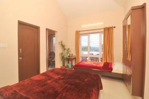 a large bedroom with a bed and a window at HIGHLAND Hills in Coonoor