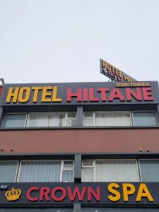 a hotel influenza sign on the top of a building at Hotel Hiltane in Kharar