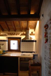 a kitchen with a stove top oven next to a window at Il Paradiso nel Borgo in Arrone
