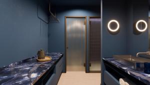 a blue bathroom with a sink and a counter top at Hotel Taro Santa Cruz in Santa Cruz de Tenerife