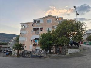 a building with a motorcycle parked in front of it at Čar Studio Apartments in Herceg-Novi