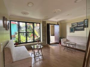 a living room with a couch and a table at Superview Lodge - Family-Run, Himalayan Sunrise in Pokhara
