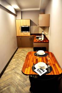 a small kitchen with a wooden table in a room at Tophane Suites in Istanbul