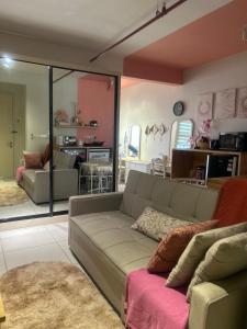 a living room with a gray couch and a living room with a living room at Lovely Luxury Poolview in Kajang +27 photos