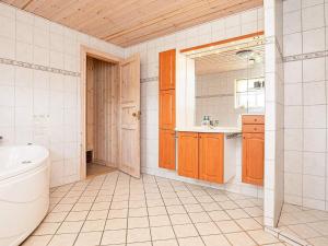 a bathroom with a toilet and a sink at 12 person holiday home in Hals in Hals