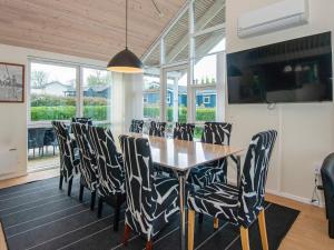a dining room with a table and chairs at 12 person holiday home in Aabenraa-By Traum in Loddenhøj