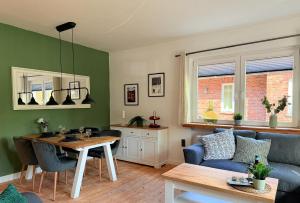 a living room with a table and a couch at Fewos Herrentor in Emden in Emden