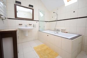 a bathroom with a tub and a sink and a mirror at Dom pod Górskim Niebem in Kobiernice +23 photos