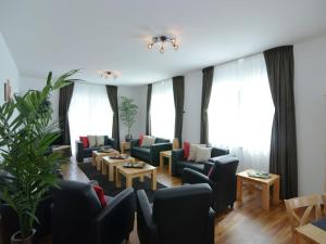 a living room with couches and tables and windows at Moderne Villa in Medebach Küstelberg in Medebach