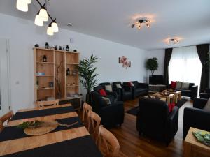 a living room with a table and chairs at Moderne Villa in Medebach Küstelberg in Medebach