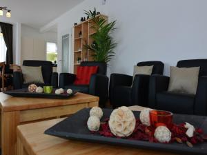 a living room with couches and a table at Moderne Villa in Medebach Küstelberg in Medebach +32 photos