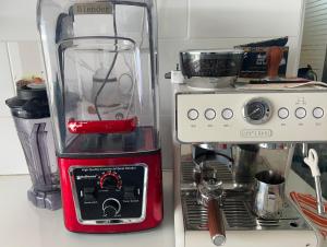 a red blender sitting on top of a kitchen counter at Mango Apartment Hotel 芒果公寓酒店 in Zanzibar City