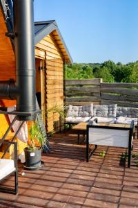 a wooden deck with couches and a fire place at Old Chalet in Iaşi
