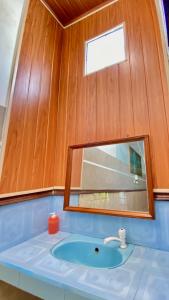 a bathroom with a sink and a mirror at Sawitri Homestay in Padangbai +49 photos