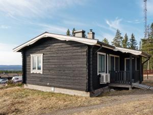 a small black house sitting on top of a hill at 6 person holiday home in Kopparberg in Kopparberg