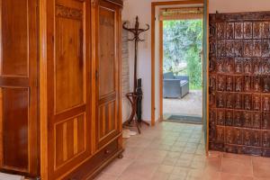 a room with a large wooden closet and a door at Márai vendégház in Kács