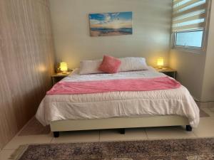 a bedroom with a large bed with two night stands at Lovely Luxury Poolview in Kajang