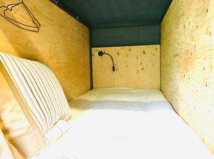 a small bedroom with a white bed in it at Hostel und Kitchen GOTOBASE in Enokizu