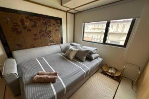 a bedroom with a bed with a mirror and a window at Avida Units Staycation near Ayala Serin Tagaytay in Kaybagal