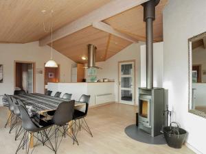 a dining room with a table and chairs and a fireplace at Luxury Retreat in Bratten - By Traum Ferienwohnungen in Jerup