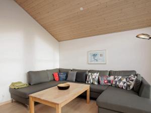 a living room with a couch and a table at Luxury Retreat in Bratten - By Traum Ferienwohnungen in Jerup +19 photos