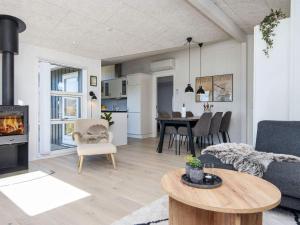 a living room with a couch and a fireplace at 4 star holiday home in Lemvig in Lemvig