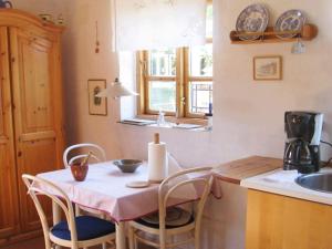 a kitchen with a table with chairs and a sink at 4 person holiday home in Bramming-By Traum in Bramming +14 photos