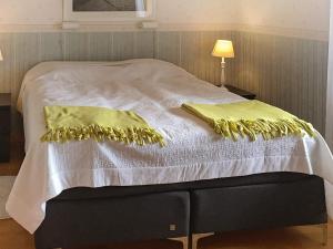 a bed with two yellow pillows on top of it at 4 star holiday home in Vara in Vara