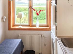 a window with a vase with flowers in it at 4 star holiday home in Vara in Vara +21 photos