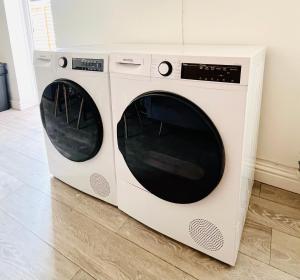 two washing machines sitting next to each other at Cleveland Road Ensuites in Portsmouth