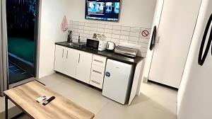 a small kitchen with a table and a microwave at Flat 2 on 8 Lindsay in Ballito