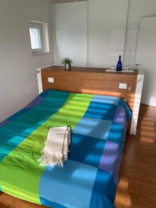 a bed with a colorful blanket on top of it at Lo Spazio dell'Anima  +4 photos