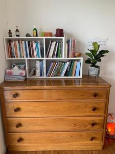 a wooden dresser with a book shelf filled with books at Lo Spazio dell'Anima 