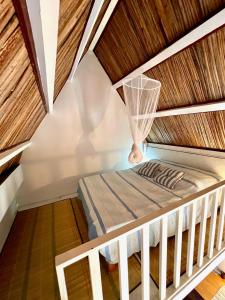 a bed in a room with a wooden ceiling at Ti Lakaz Kreol 2 in Pereybere +34 photos